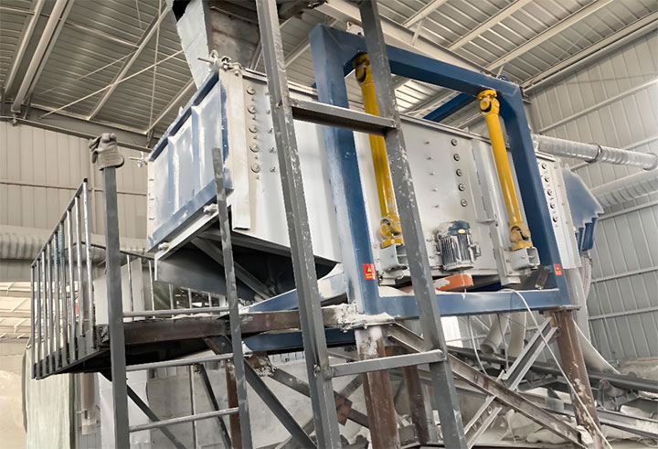 Square gyratory sifter operating on a structural platform inside a flour mill or feed processing plant